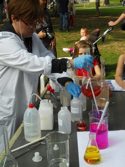 un'immagine della seconda edizione: bambini intenti a svolgere esperimenti chimici
